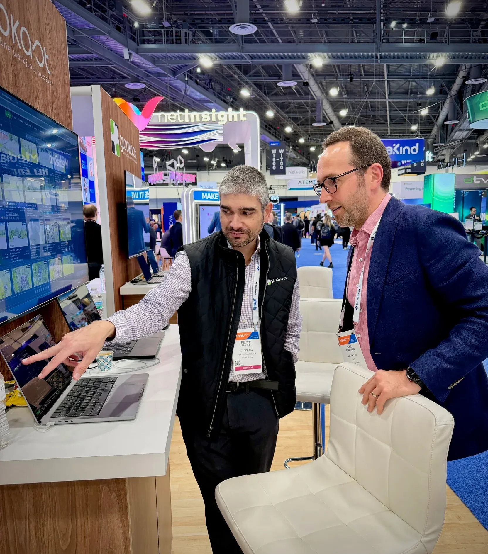 Ben Swanton with Felipe from Glookast, looking at a laptop demo on the Glookast stand at NAB Show Las Vegas 2026